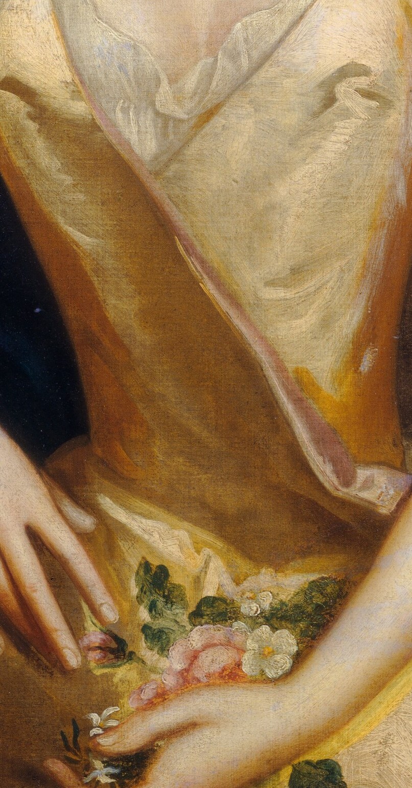She holds a long chain, likely a rosary, in devotion.