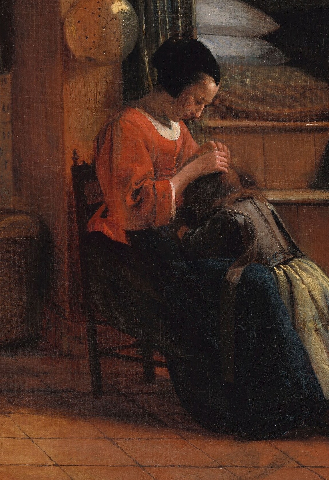 This mother, deep in thought, combs her child's hair.