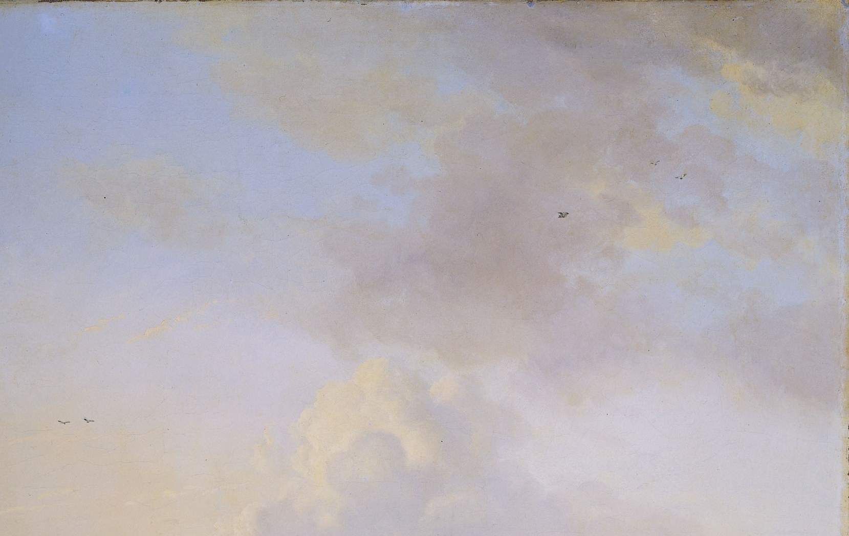 nearly a third of the canvas is sky; the warm golden light on cloud undersides signals low afternoon sun and sets the entire color temperature of the scene