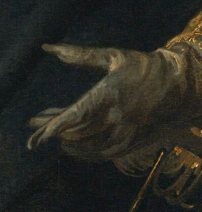 He holds a baton in his gloved hand.