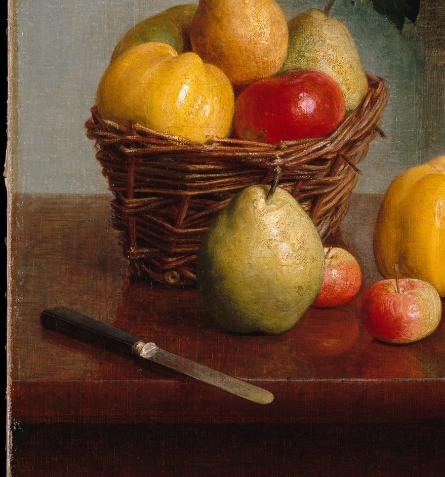 A wicker basket, spilling pears.