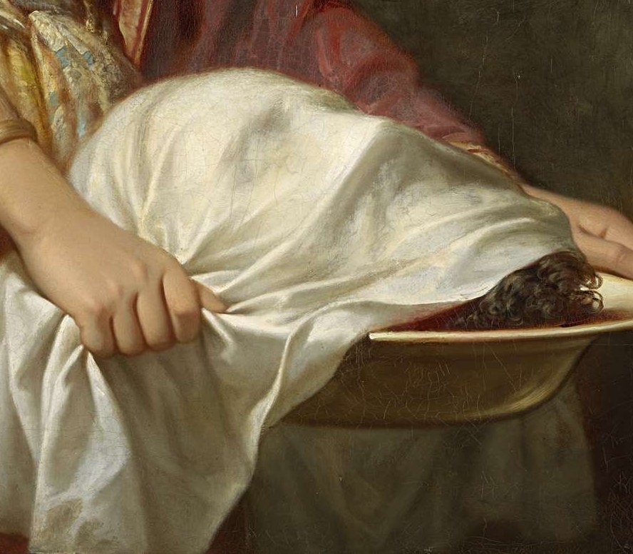 The head of John the Baptist, half-hidden beneath a cloth.
