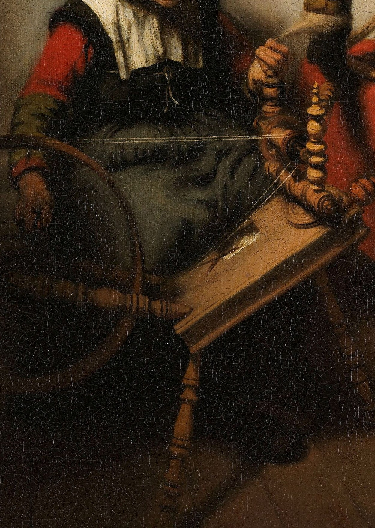 A woman spins thread, a common household task.
