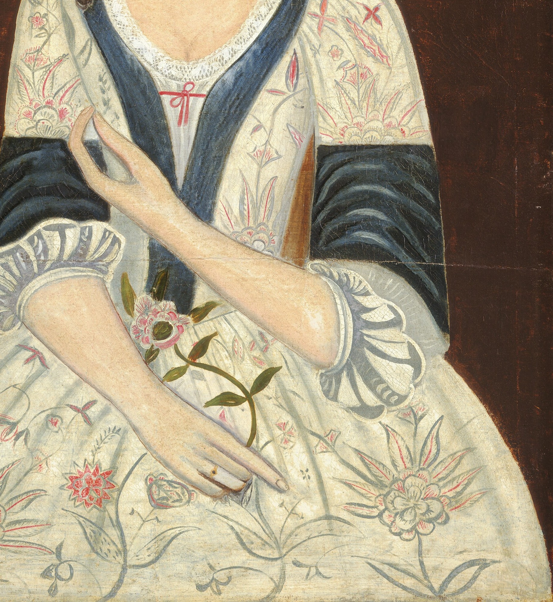 Her dress shows the wealth of a colonial family.