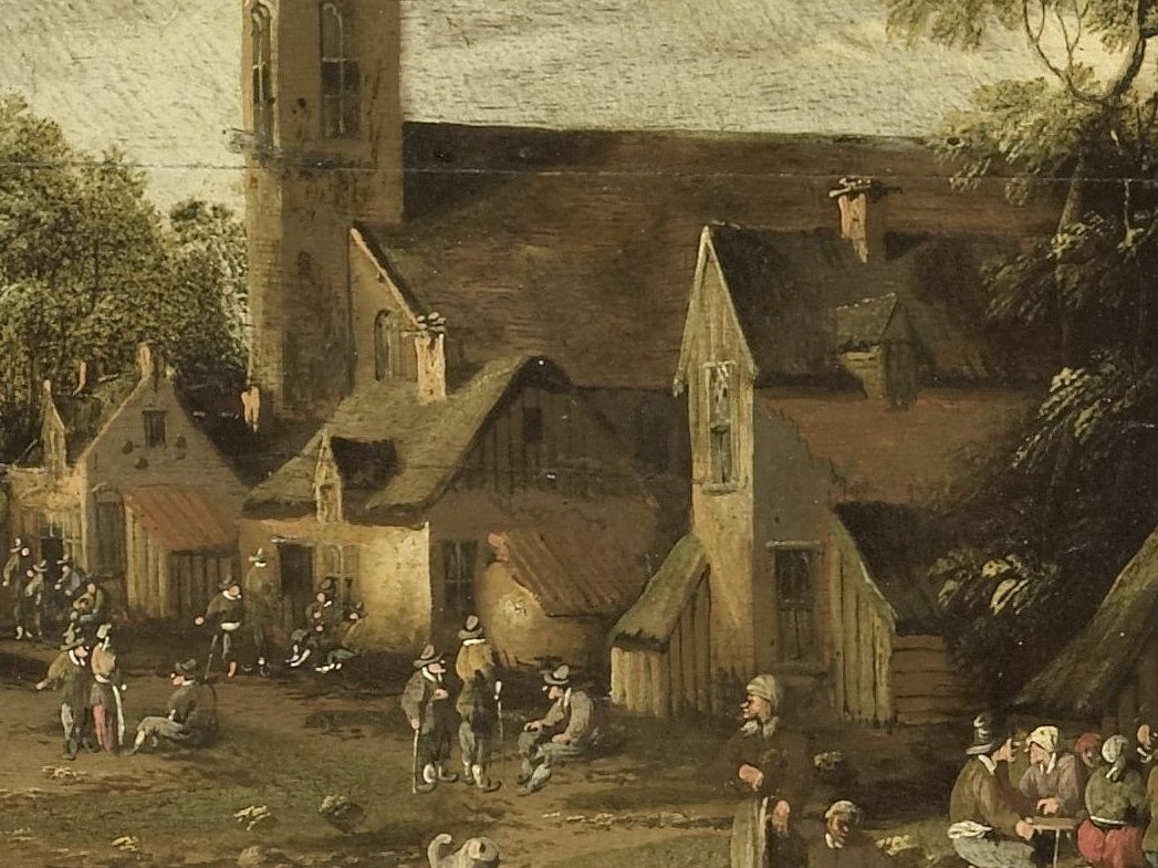 The thatched-roof houses line the cobbled street.