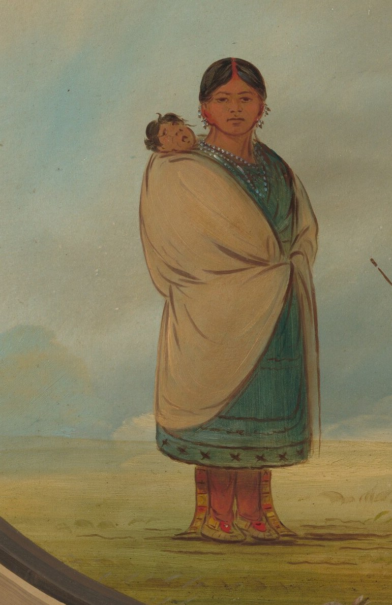 A woman carries her infant, emphasizing family roles.