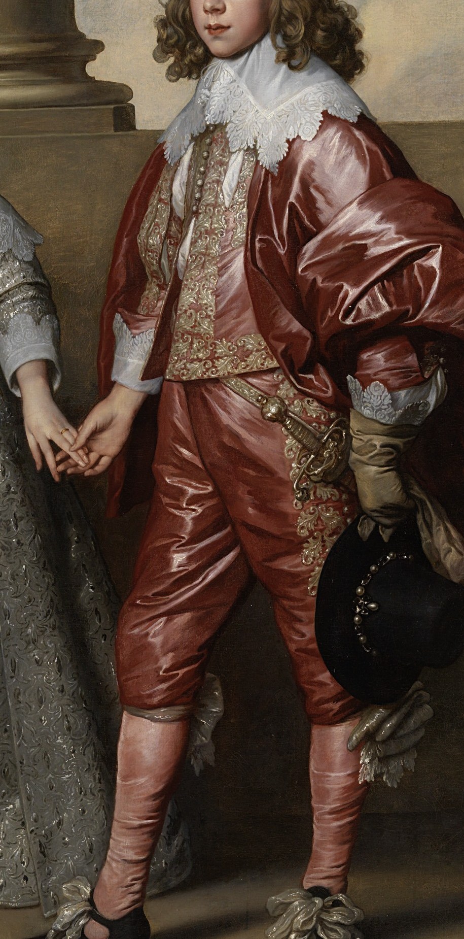 Slashed doublet with lace falling collar; the saturated red commands the right half of the canvas and signals martial princely rank.