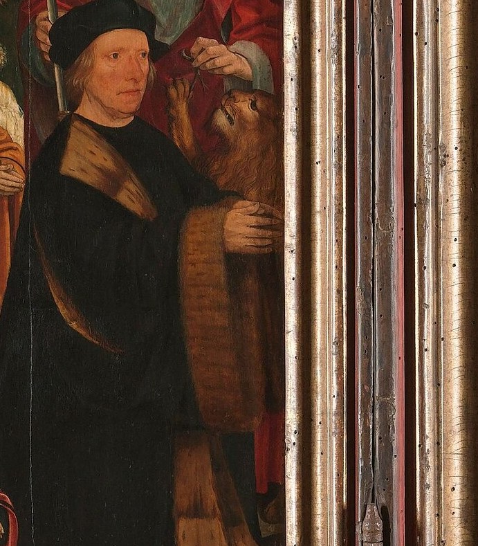 But look at the man in the dark robe and hat.