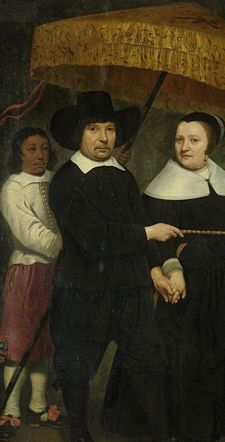 Look closer at the person holding the parasol.