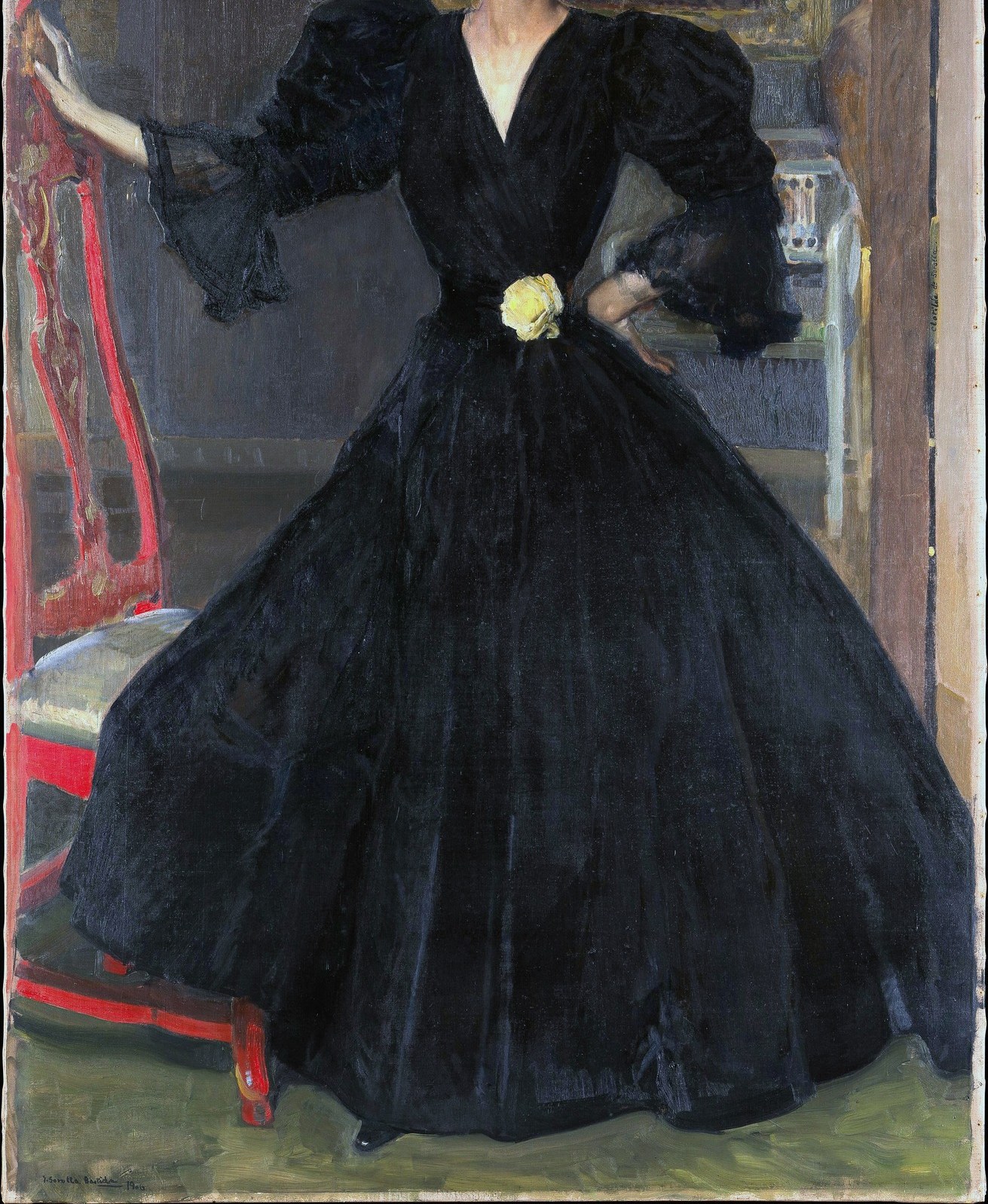 She wears a deep black dress in their Madrid home.