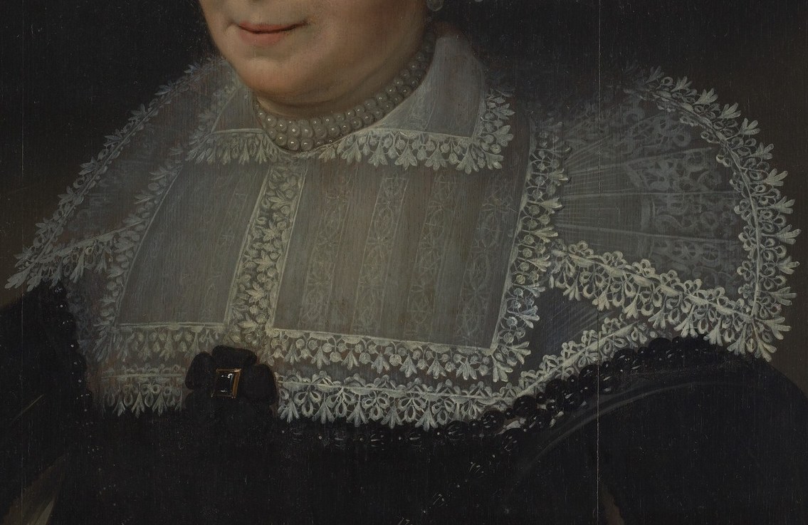 But look closely at her lace collar.