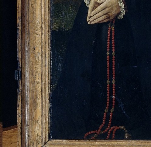 And her rosary, a symbol of faith and status.