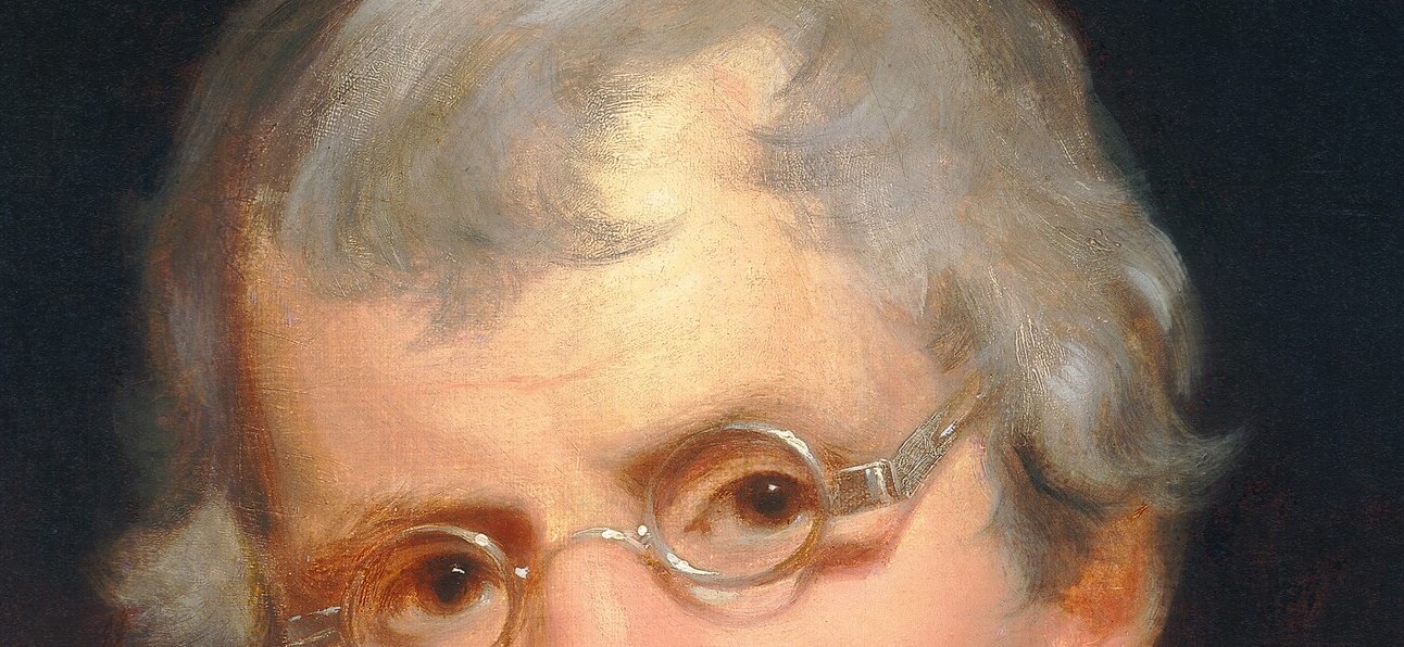Wire-rimmed spectacles: a rare accessory for a portrait.