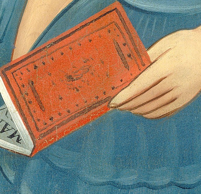 Her sister carries a small red book, open to show text.
