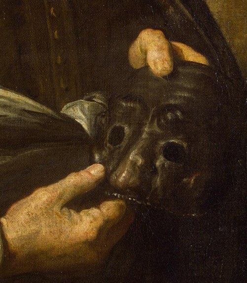 He holds a mask, the symbol of his commedia dell'arte craft.