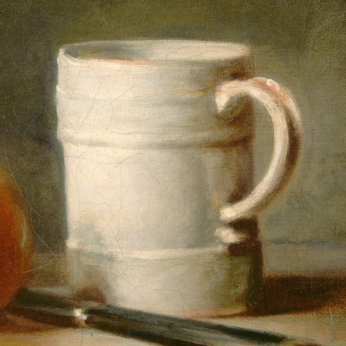 Look closely at the surface of this simple white mug.