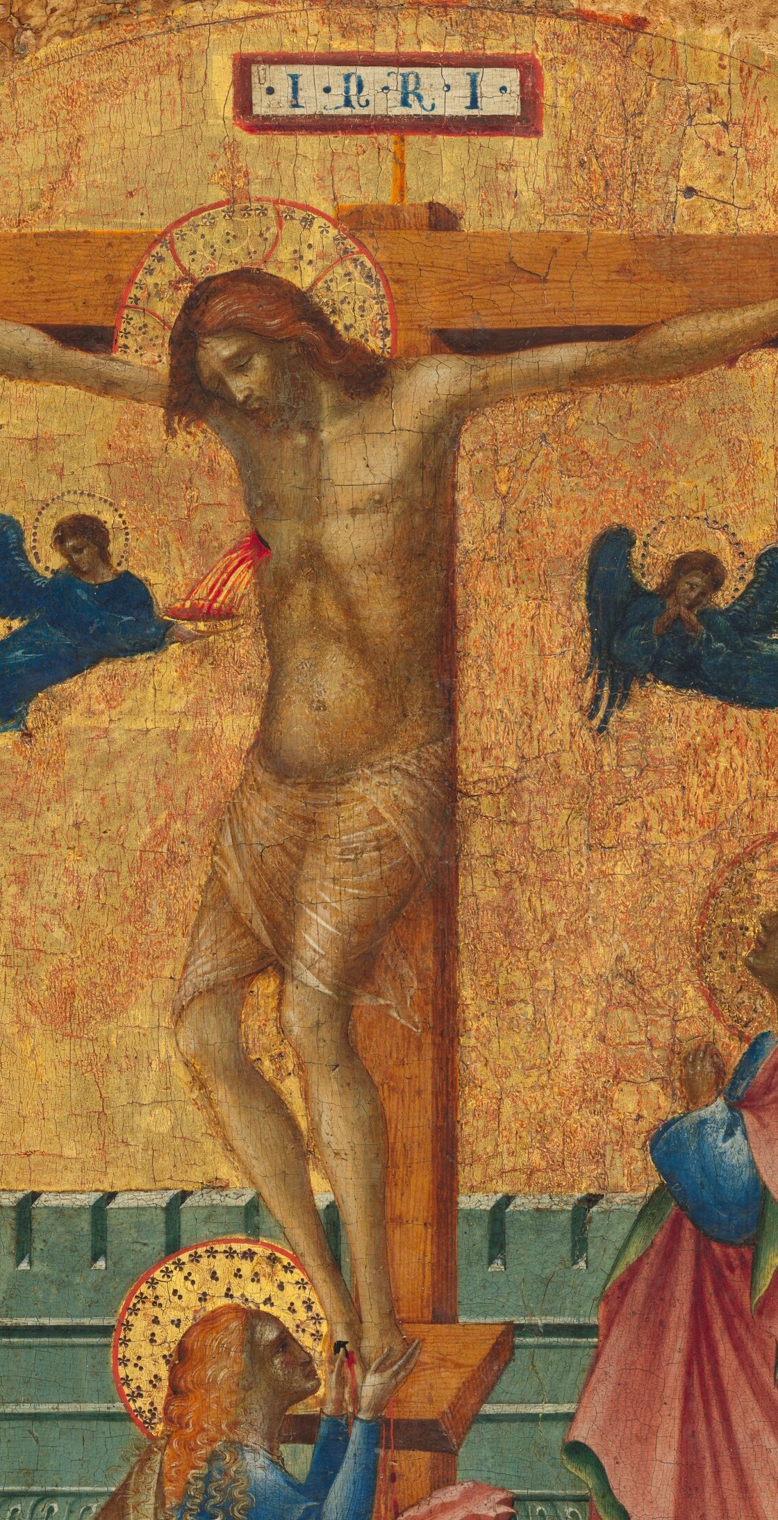 The compositional and theological fulcrum , the elongated, loincloth-draped body with arms outstretched anchors every gaze in the scene.