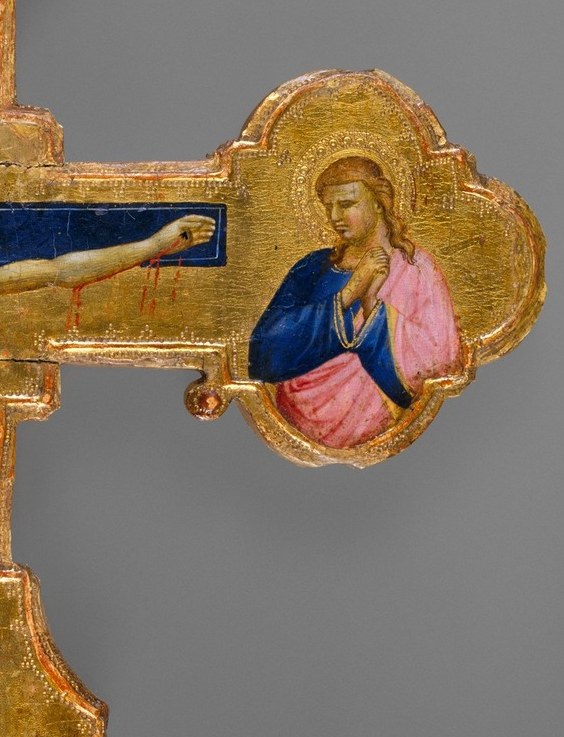 Likely St. John the Evangelist; his contrasting pink robe against the dark background creates vivid color dialogue with the Virgin
