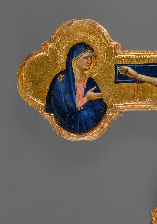 Rendered in blue with gold accents, her gesturing hands and sorrowful pose embody maternal grief