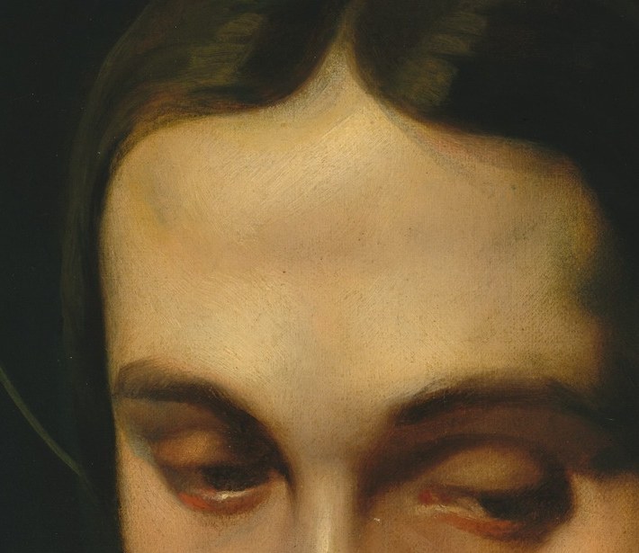 His dark hair frames a face of deep thought.