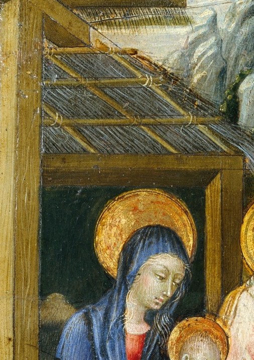 His reddish garment and gold nimbus mark him as honored witness; his gesture toward the child bridges the holy family and the arriving Magi.