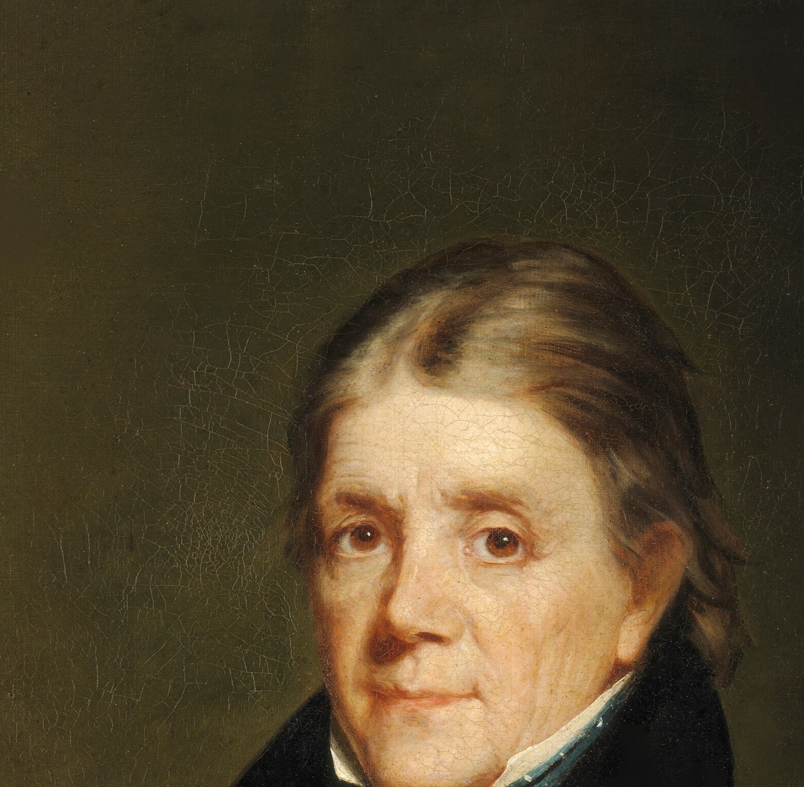 The face, pale and gaunt, appears to glow from within.