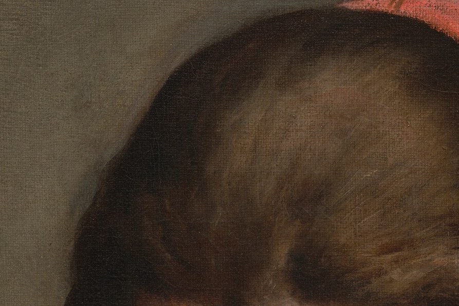 Notice her downcast eyes, absorbed in her work.