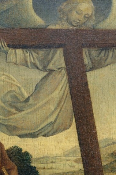 There, barely visible, a man hangs on a cross.