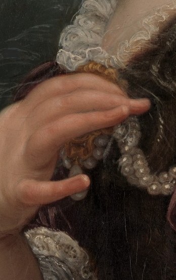 Look closely at her left hand, resting on her chest.