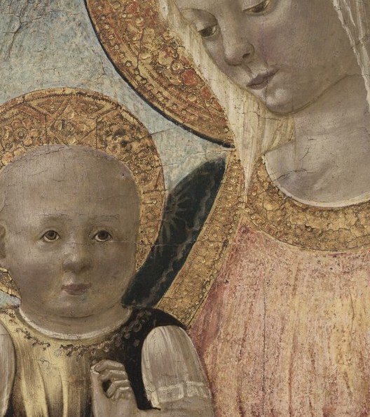 The Christ Child looks outward, making eye contact with us.