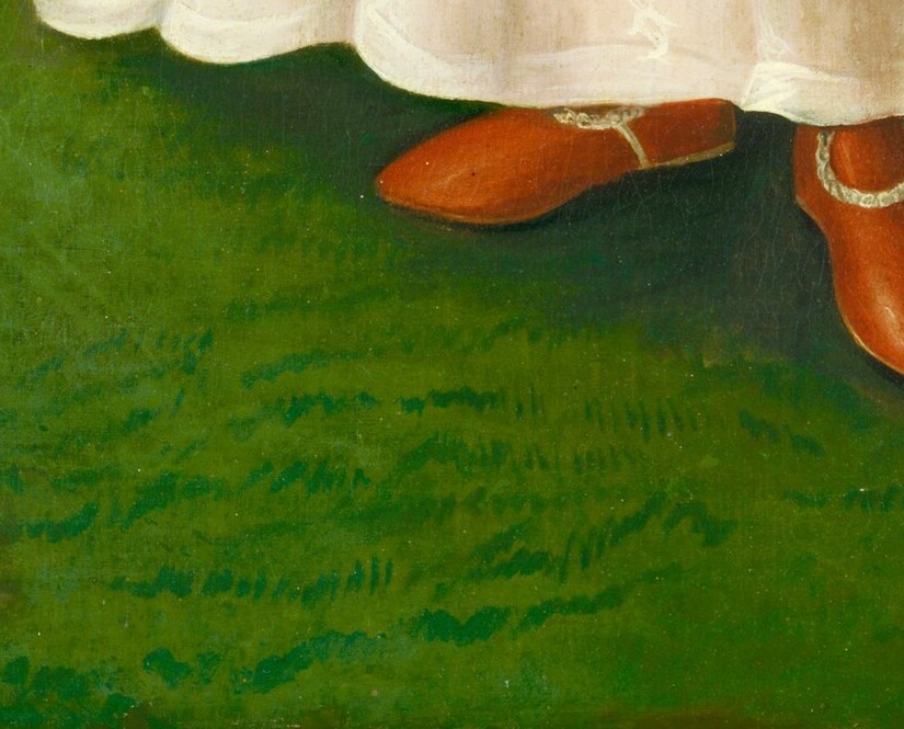 A shock of bright red shoes peeks out, a surprising luxury.