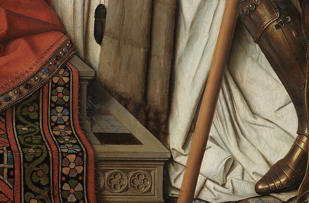 His furred cloak signals wealth and status.