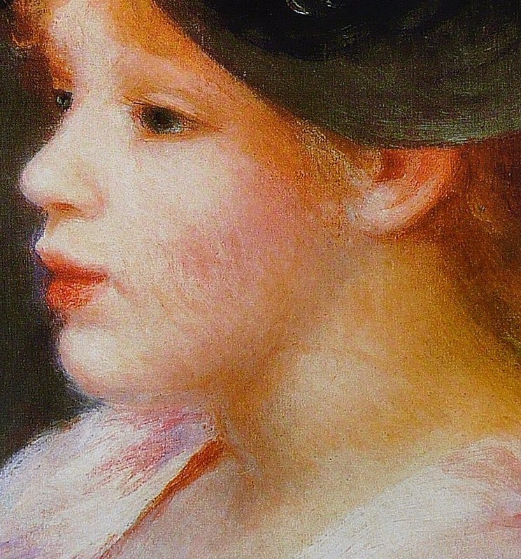 This young woman looks away, lost in thought.