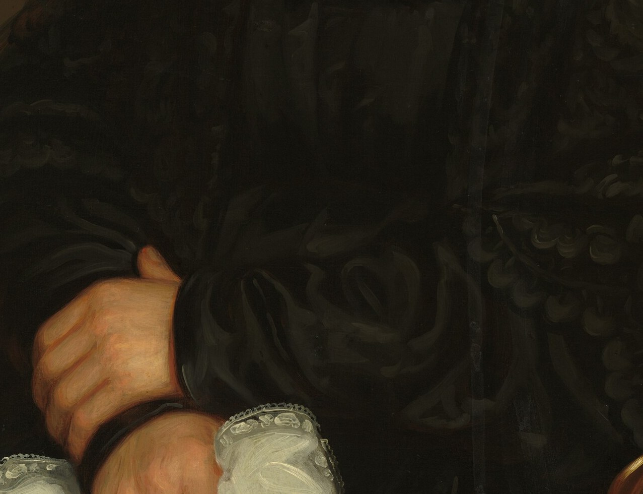 Her hands, crossed in her lap, signal respectability.