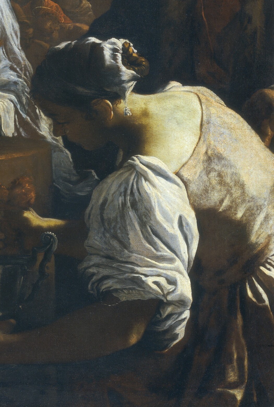 But look at the woman, bowed in sorrow or prayer.