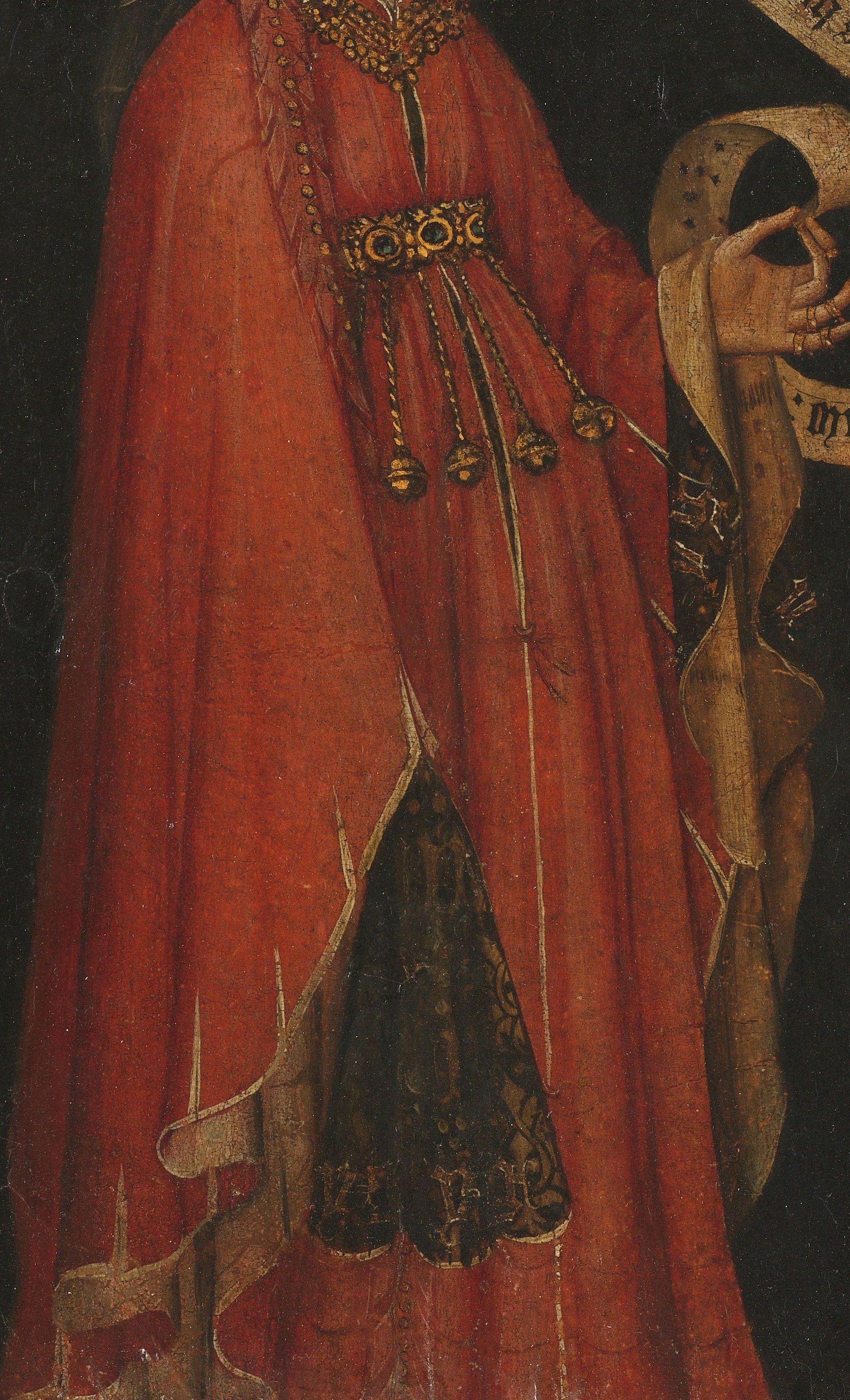 The rich red robe and gold embroidery display her wealth.