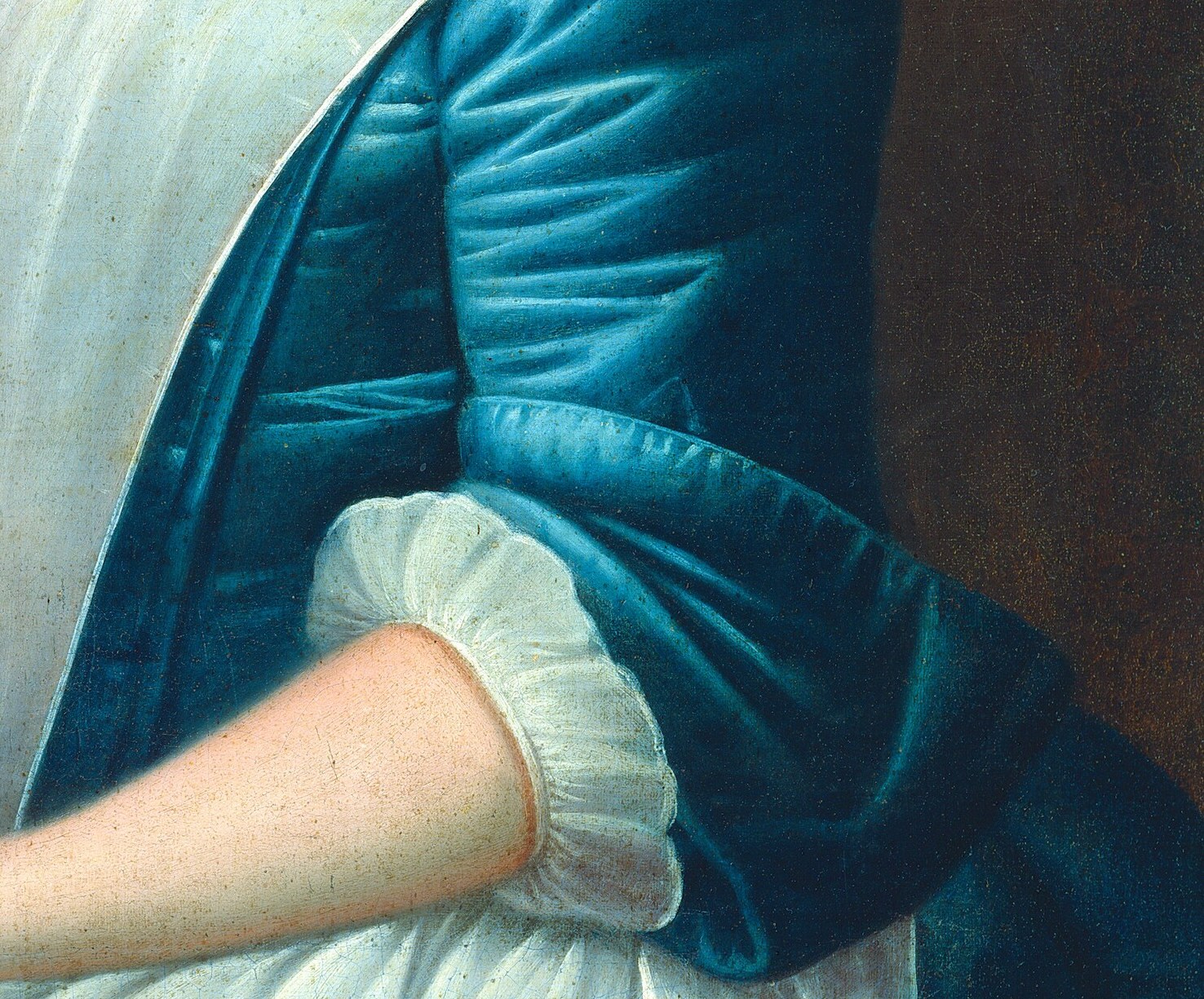 She wears a blue satin dress and a crisp white apron.