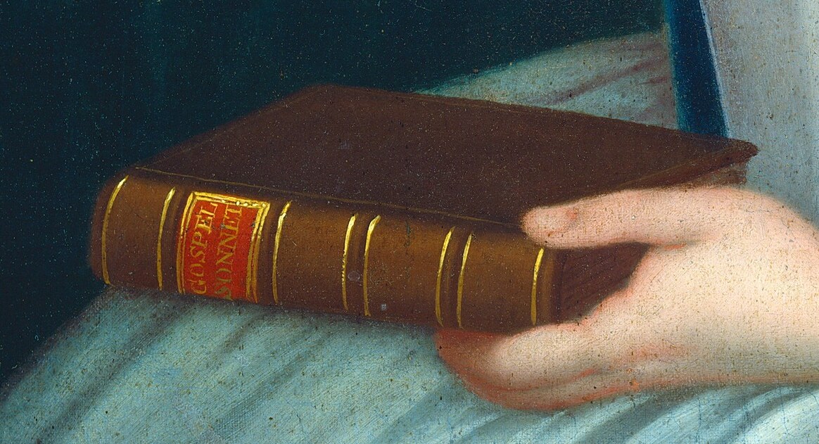 This pose suggests both contemplation and literacy.