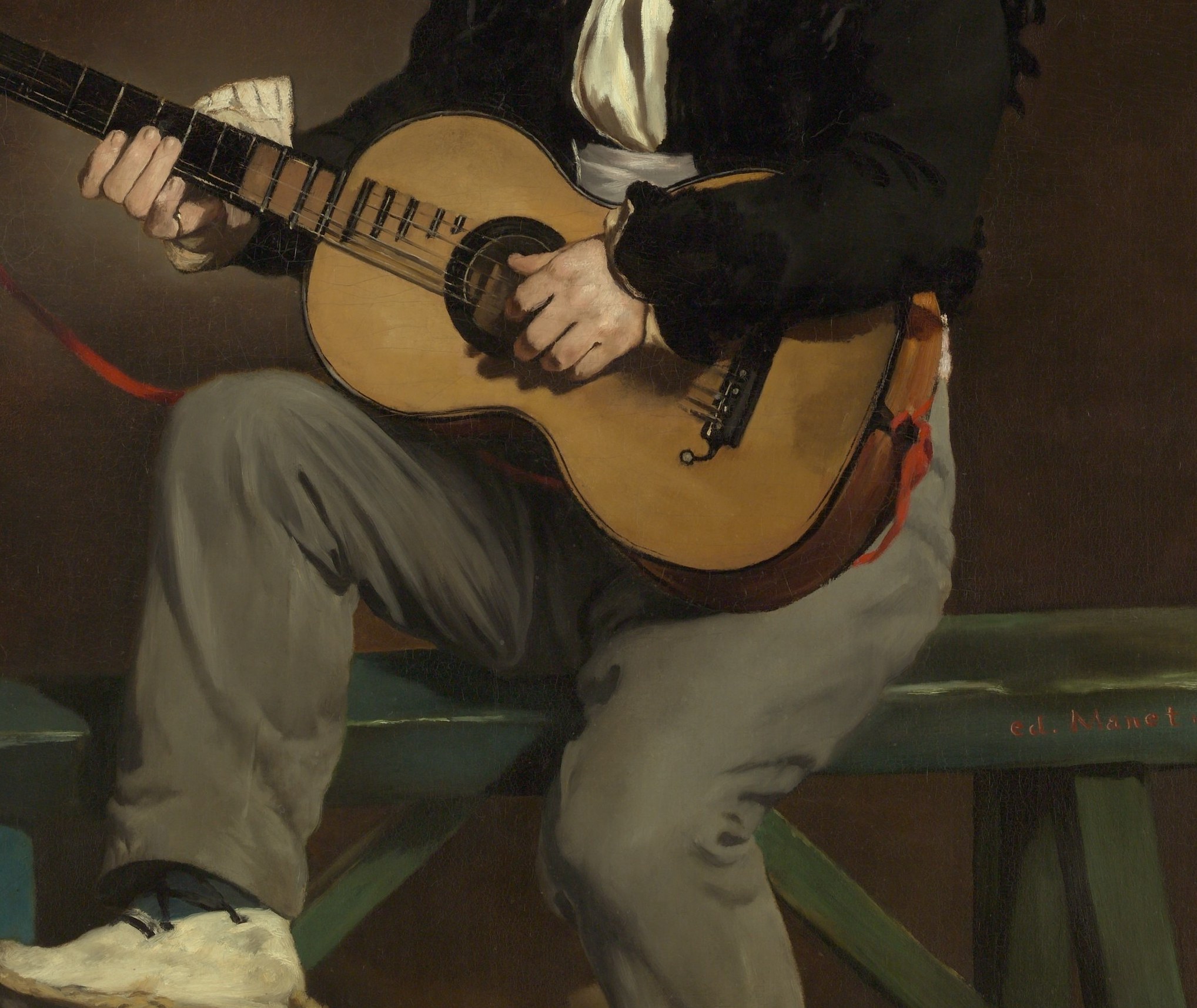 Central prop and the painting's whole raison d'être; Manet renders the warm wood grain with bravura brushwork, anchoring the Spanish subject matter.