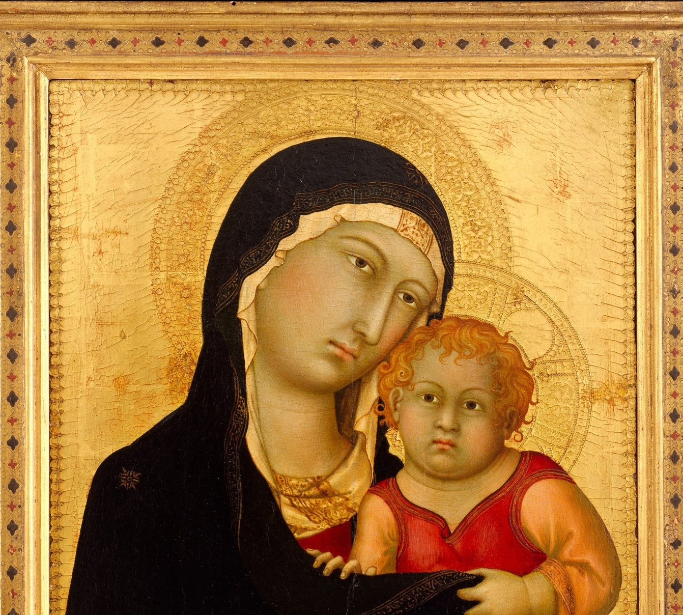 The undifferentiated gold ground eliminates earthly space entirely, placing the figures in sacred timelessness; visible between the halos and along the edges, it is the visual argument that this is icon, not narrative.