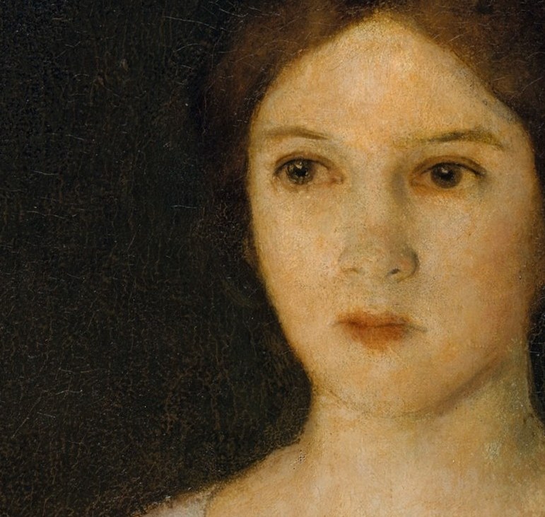 Her gaze is direct and slightly melancholic.