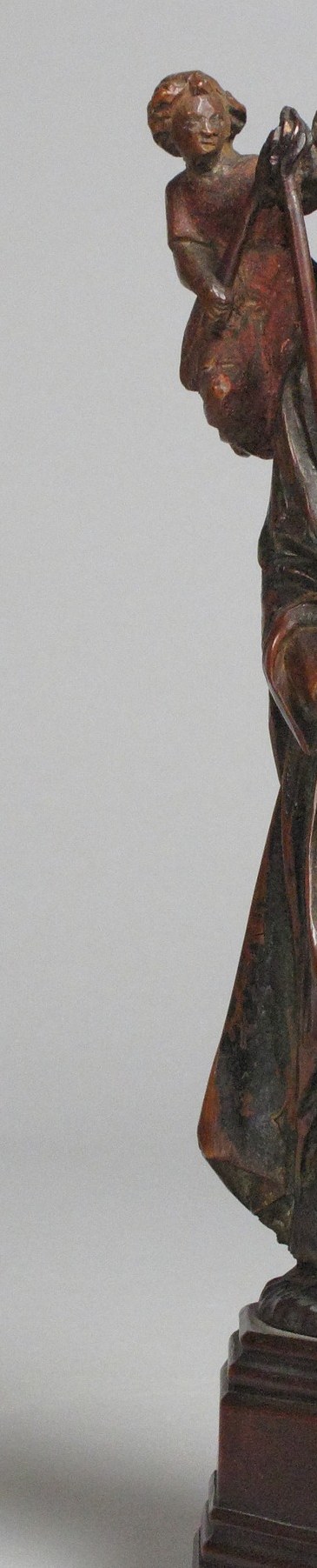 The staff is the spine of the composition , it marks Geneviève as a shepherd-protector of Paris and visually anchors all three figure levels