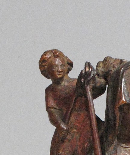 Easy to miss at first glance , once seen, it reframes the whole sculpture; a tiny soul or allegorical figure standing on a saint's shoulder is rare iconography that demands explanation