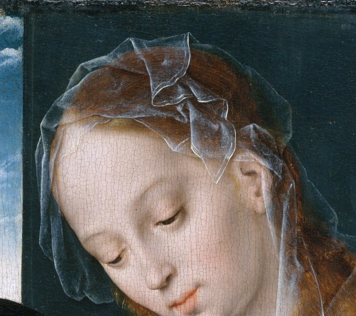 Eyes cast down in tender absorption , the emotional anchor of the entire composition; her expression carries quiet devotion.
