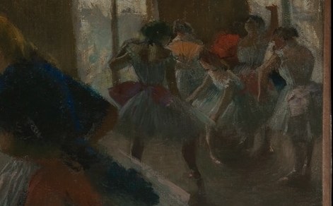Other dancers stretch and wait, showing the labor behind the spectacle.