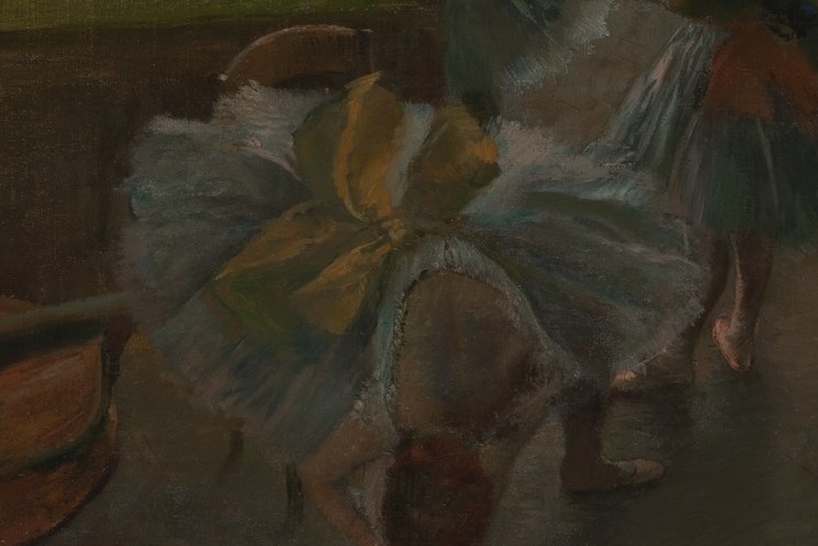 This dancer in blue seems lost in thought, holding a yellow ribbon.