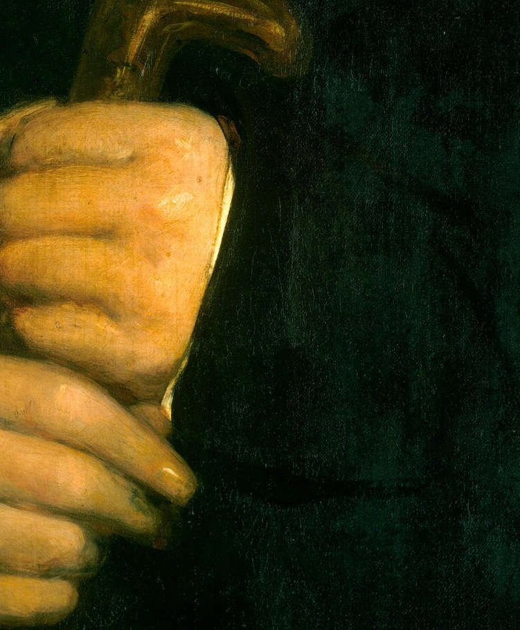 His folded hands grip a familiar walking stick.