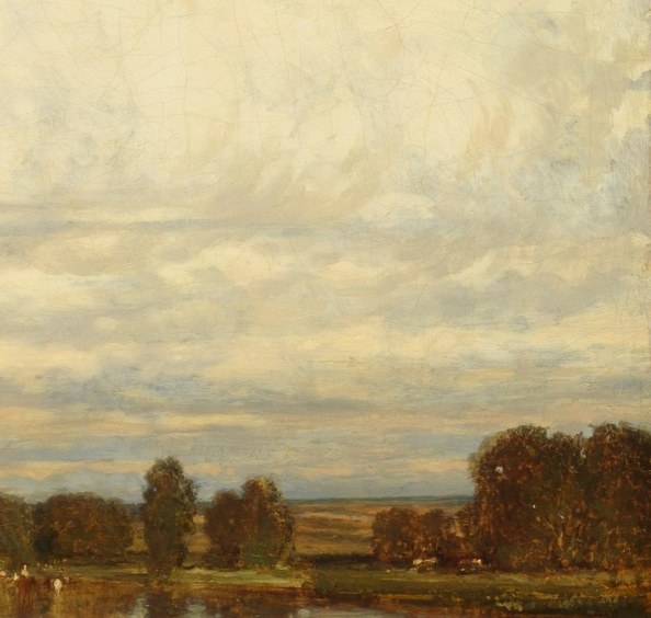 Acts as a dark coulisse framing the right edge and anchoring the horizon; the backlit foliage edge is crisply rendered against pale sky