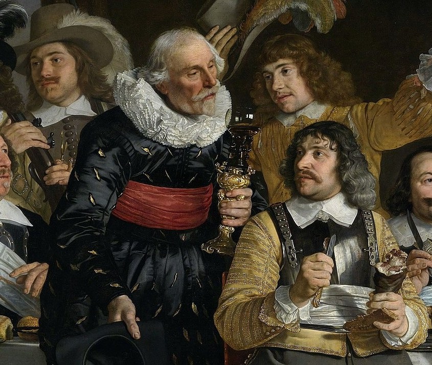 His prominent position and rich attire indicate his importance within the guild.