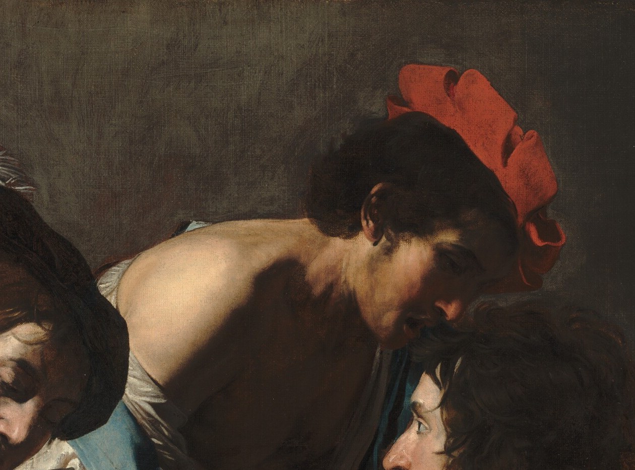 Look at the man in the red cap. His gaze is intent on the game.